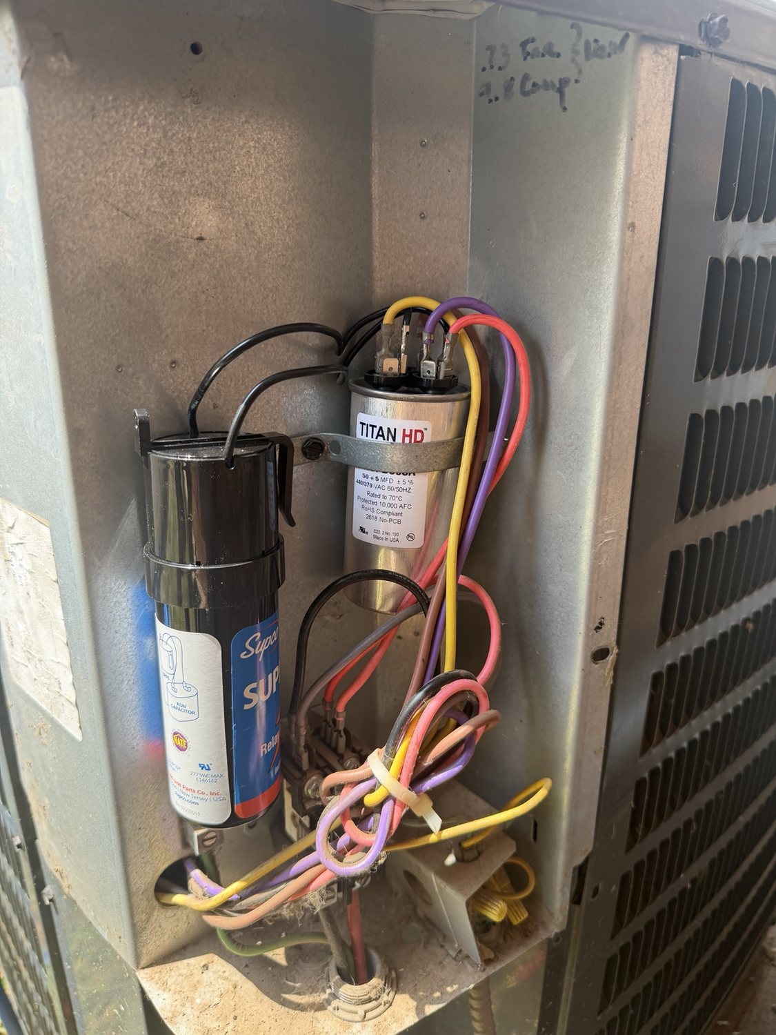 Installed HVAC capacitor and wiring inside outdoor unit